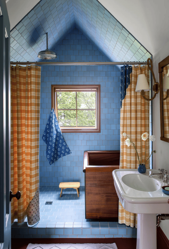blue tile shower with yellow curtain
